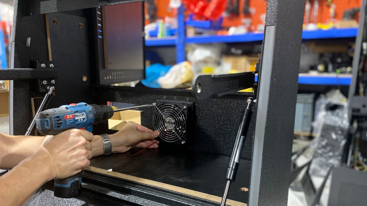 Technician installing a cabinet cooling fan